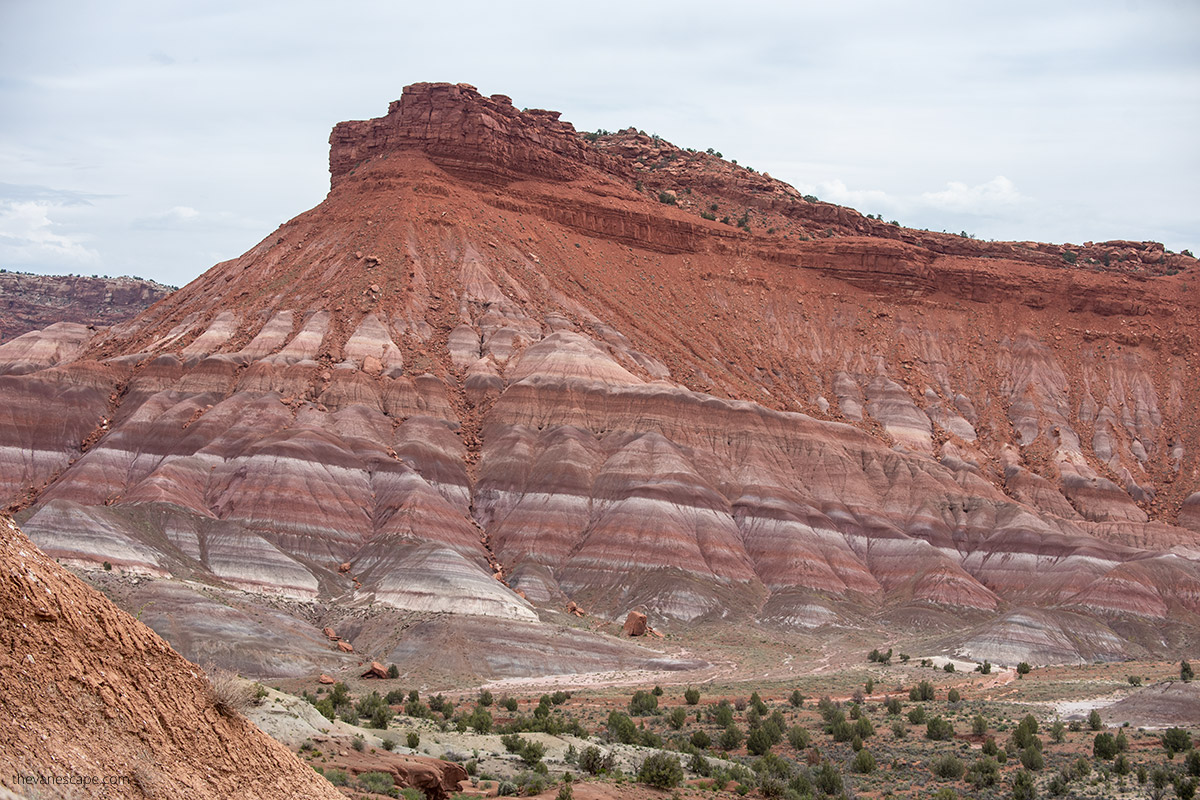 Famous rock in Paria Townsite in Utah was a movie set for many Western films. The rock has many colors, shades of rust, red, purple, purple, gray, and white. 