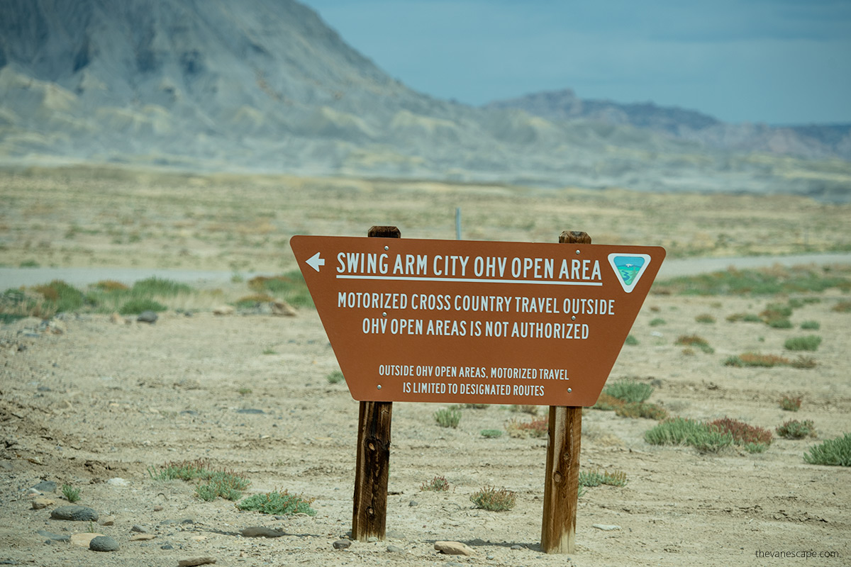 a wooden board informing about the area available for OHV vehicles, know as Swing Arm City OHV
