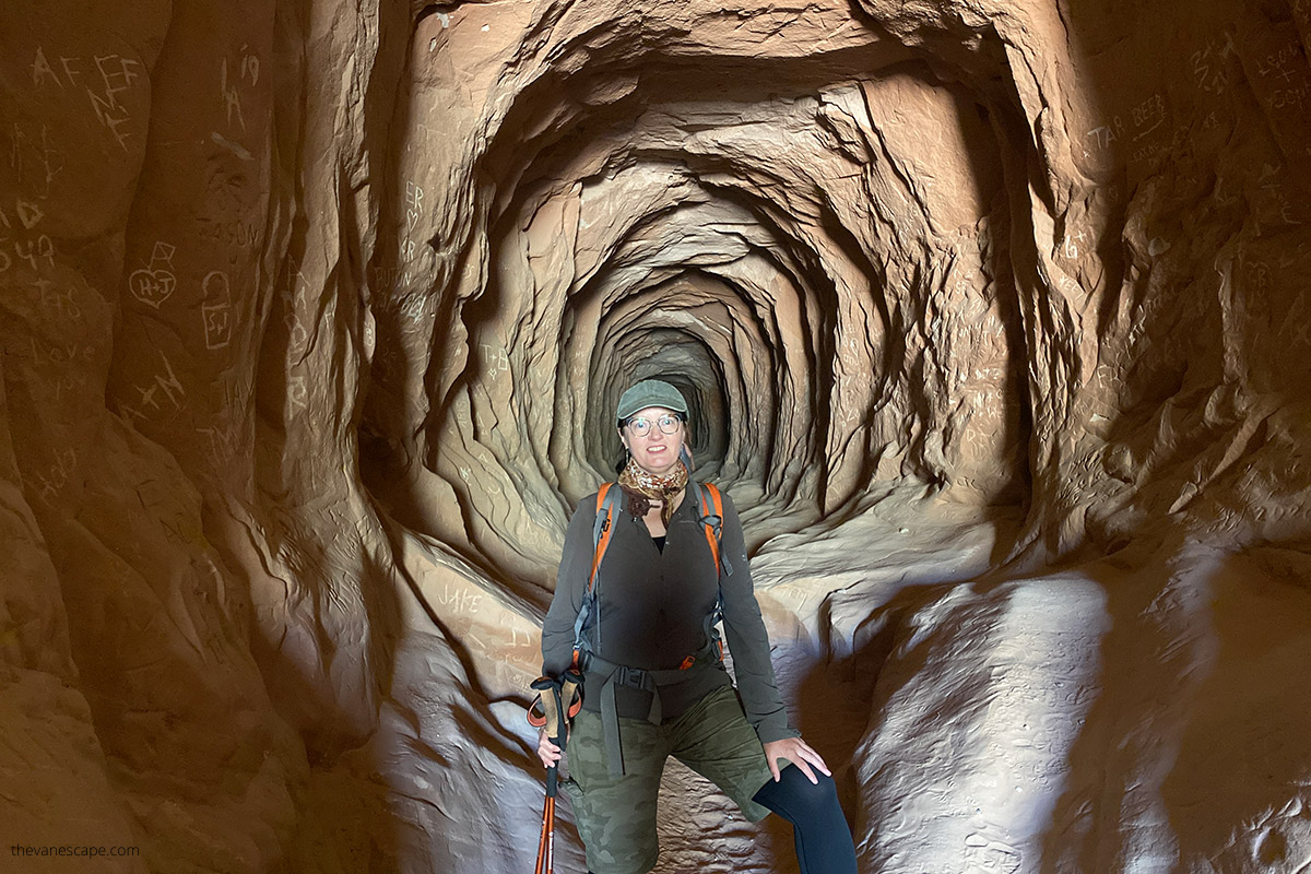 Agnes hiking in the Belly of the Dragon tunnel near Kanab