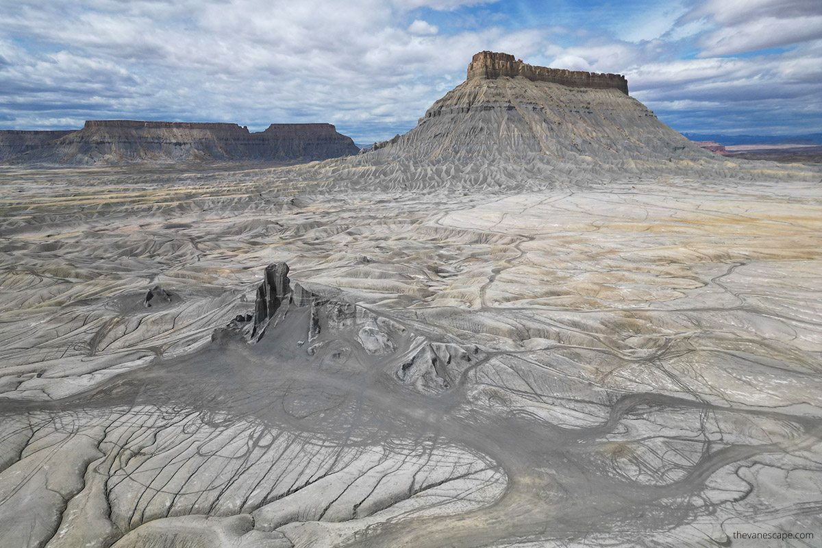Aerial view (photo taken by drone) showing vast lonely Factory Butte in Utah and empty moon-like gray space around