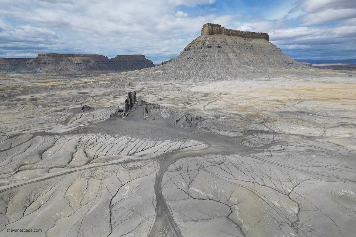 Aerial view (photo taken by drone) showing vast lonely Factory Butte in Utah and empty moon-like gray space around