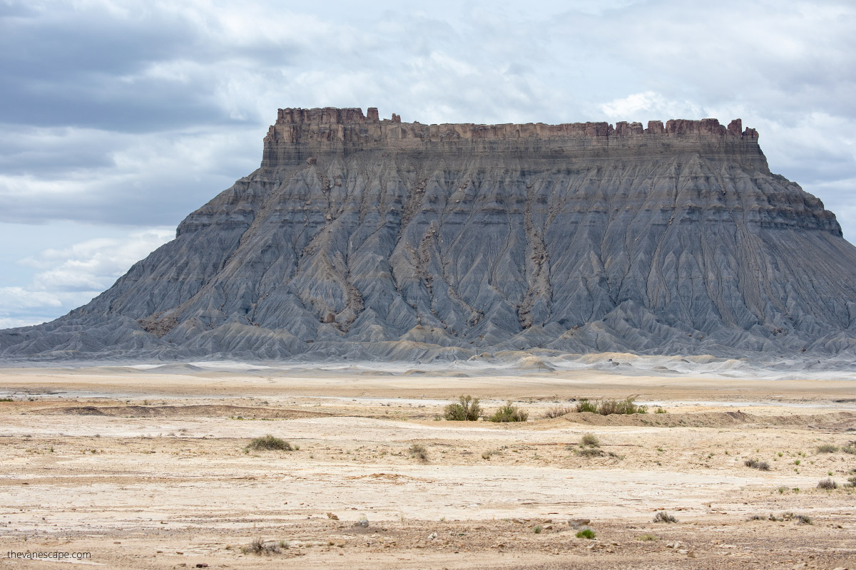 huge and high Factory Butte surrounded by flat surface