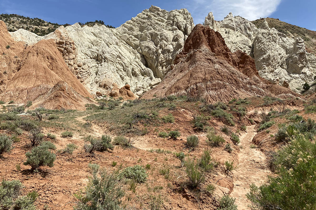 hiking path along the road with view of white and oranges rocks