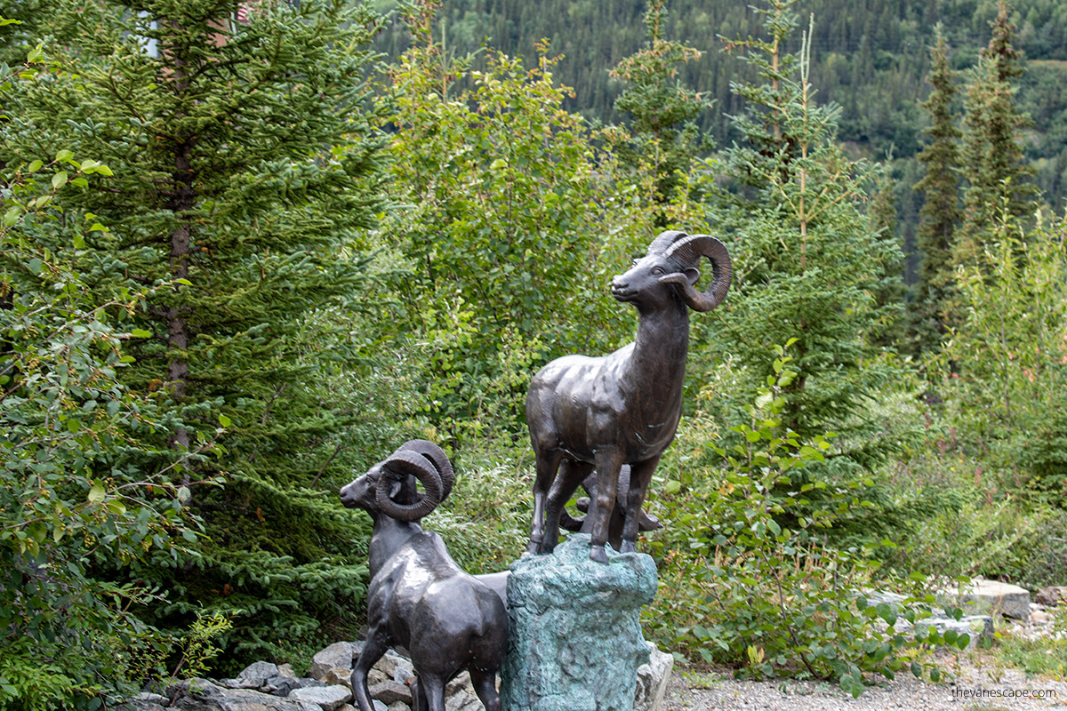 Dall sheep statues in McKinley Park near Denali among trees