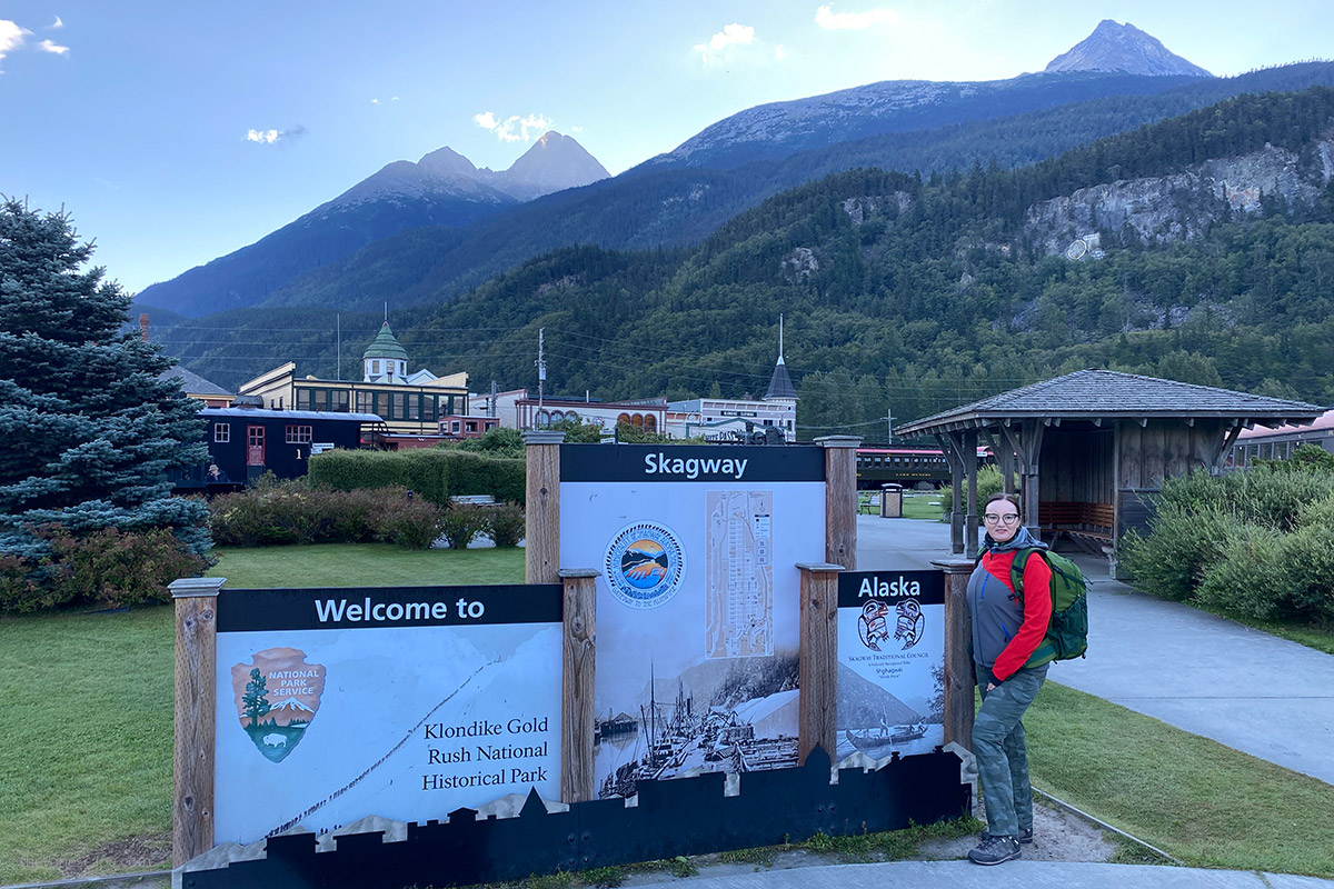 agnes with skagway sign with mountains in the backdrop