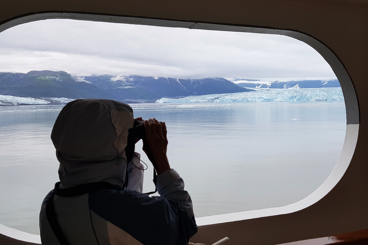admiring glacier through binouclars- must have item for alaska cruise packing list