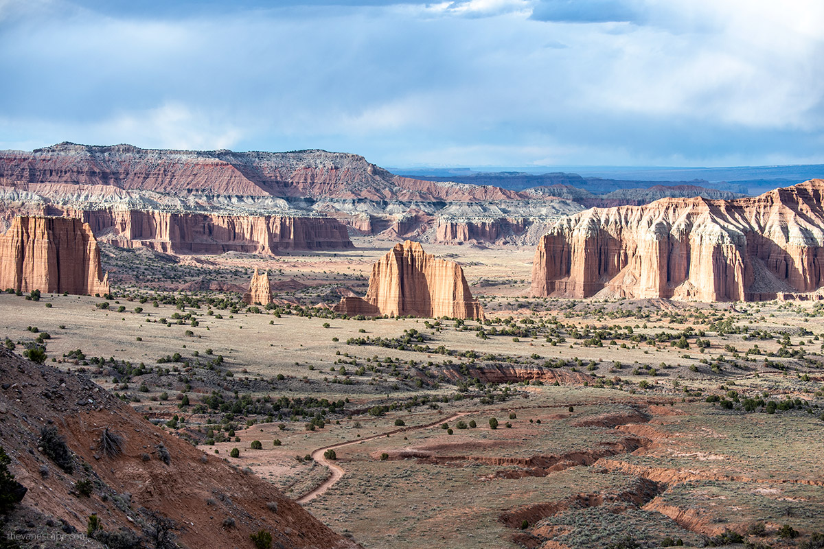 cathedral valley loop- stunning view of rock formations and dirty road before sunset from upper overlook