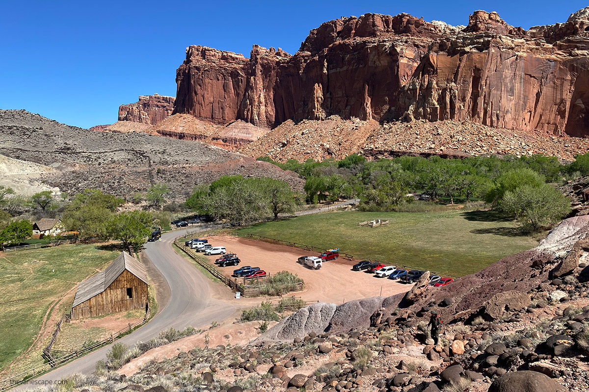 the large wooden barn - Pendleton Barn  from the iking trail with the backdrop of huge walls of capitol reef.