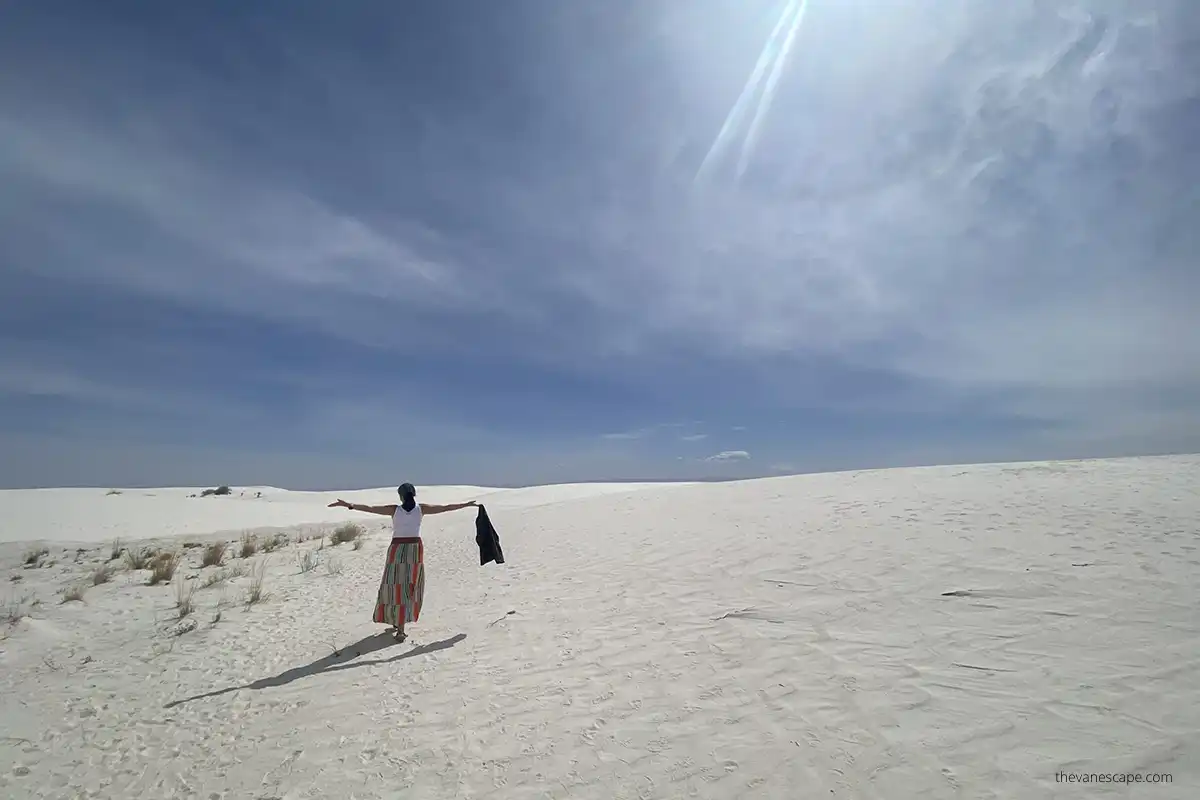 Agnes visiting and enjoying white sands dunes during sunny spring day.