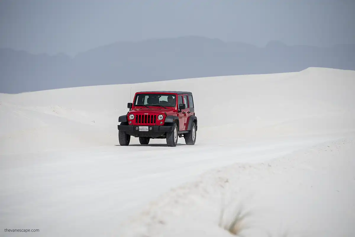 our red rented jepp wrangler among white dunes in the park.