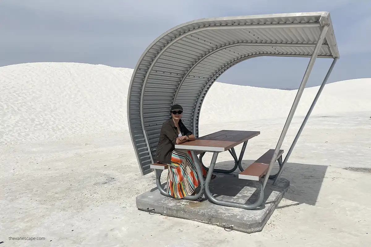 Agnes sitting in a shelter in the picnic area in White Sands National Park. 