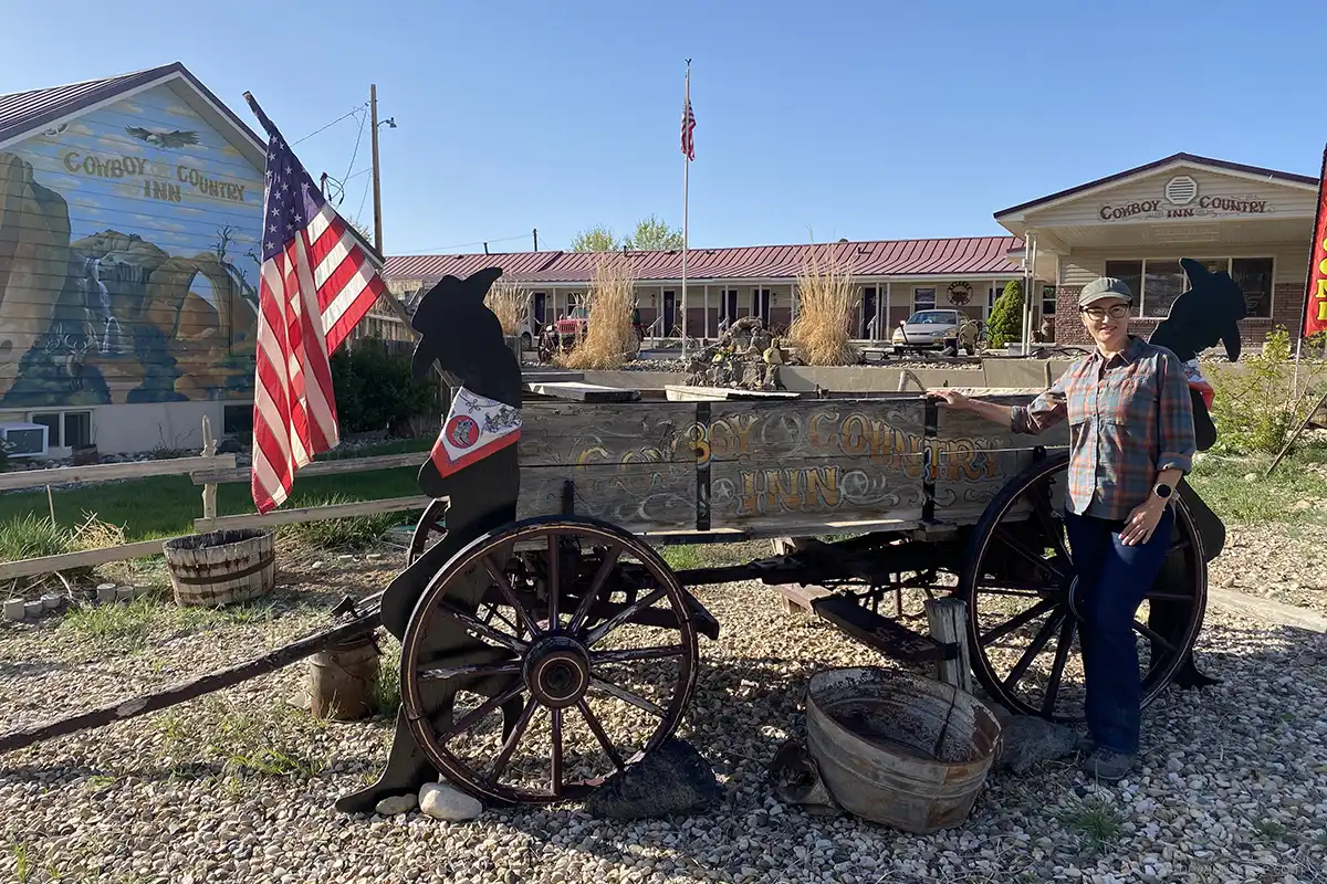 Agnes in a front of Cowboy Country Inn - one of the best hotels in Escalante, Utah.